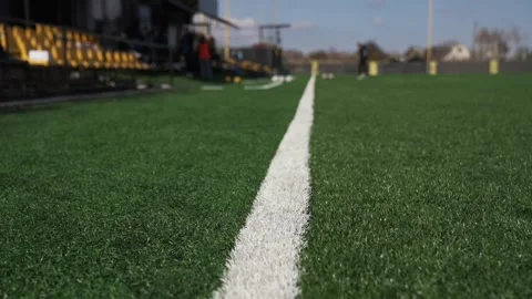 Sideline marking edge of soccer field against background of football players 库存影片 330949149