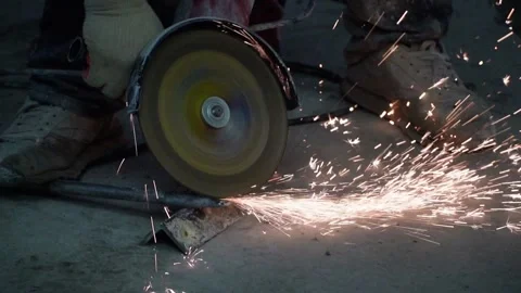 The sides fly bright sparks from the angle grinder machine. Stock Footage 329798896