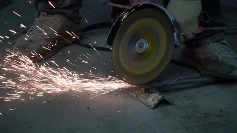 The sides fly bright sparks from the angle grinder machine. Stock Footage 329798899