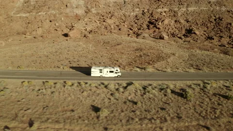 Sideview drone footage of RV driving along road on American road trip in Stock Footage 146561548
