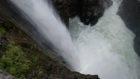 Sideview of a large cascade with the water plunging down, a tropical paradise Stock Footage 152862212