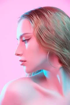 Sideview portrait of a beautiful red-haired girl with light makeup posing on  Stock Photos