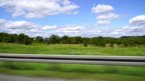 Sideview of a ride on a highway with clouds and trees on sunny day Stock Footage 158542209