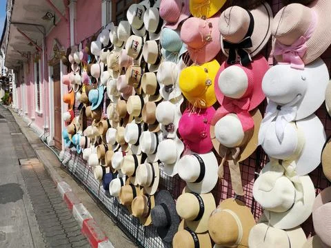 Sideview of store stand with a row of hats in different colors and designs. Stock Photos