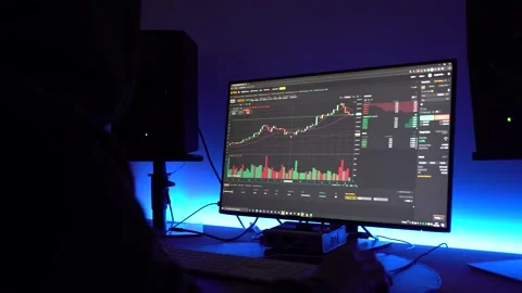 Sideview of a trader looking at financial chart trading bitcoin and Stock Footage 149541082