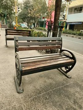 Sidewalk benches arranged Stock Photos