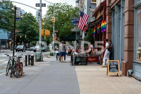 Sidewalk cafe decorated with gay pride rainbow flags Stock Photos