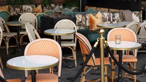 Sidewalk cafe  with small round tables and empty chairs - coffeehouse, coffee Stock Footage 232083534