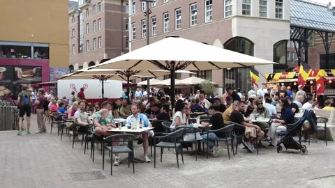 Sidewalk cafes on Grote Markt full of people on weekend Stock Footage 282810565