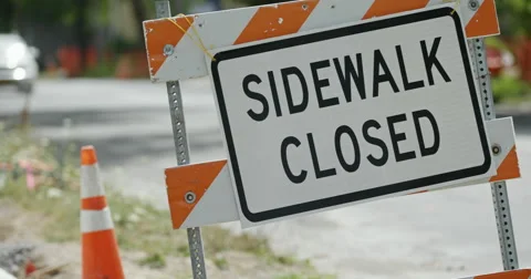 Sidewalk Closed Sign Close Up with Traffic Stock Footage 65730543