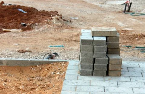 Sidewalk construction and stack of concrete blocks Stock Photos