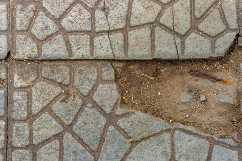 The sidewalk floor is damaged and needs repair Stock Photos
