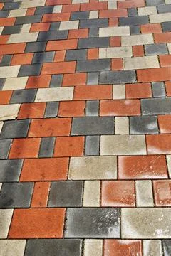 The sidewalk is lined with multi-colored stones. Stock Photos
