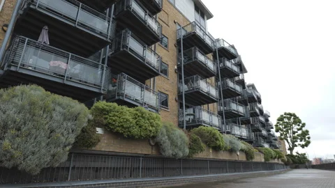 A sidewalk by a modern apartment building. Stock Footage 276711483