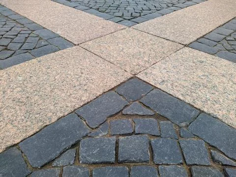 Sidewalk in the park lined with tiles in the spring season Stock Photos