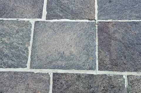 The sidewalk is paved with stone tiles Stock Photos