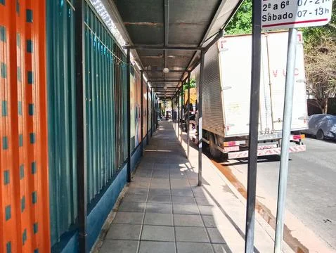 Sidewalk in perspective, with protection of the work. Stock Photos