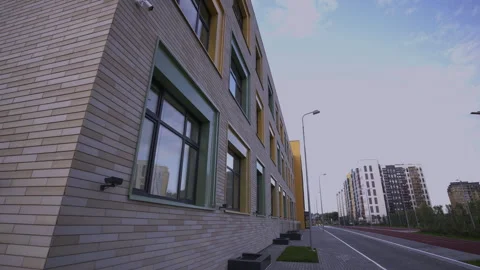 Sidewalk runs parallel to row of residential buildings Stock-Footage 279134215