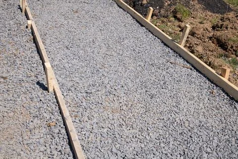 A sidewalk is under construction, a concrete curb is being installed and th.. Stock Photos