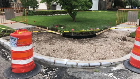Sidewalk under construction. Safety barrels and caution tape Stock Footage 158060457