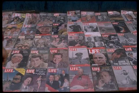 Sidewalk vendor's array of collectible-era LIFE mags., featuring famous faces, s Stock Photos