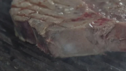 Sideway pan around the raw frying steak Stock Footage 80689744