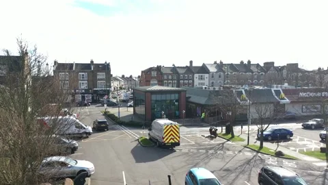 SIDEWAY TRACKING SHOT VEHICLE LEAVING MC DONALDS IN LONDON Stock-Footage 149947398