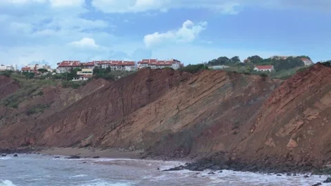 Sideways aerial drone panning view of erosion impact on coastal cliffs observed Stock Footage 287992731