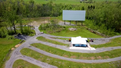 Sideways aerial view of empty drive-in movie theater Stock Footage 131128027
