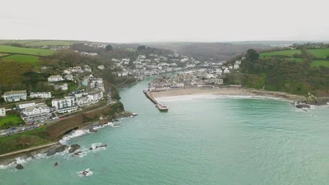 Sideways aerial view of Looe harbour and coastal town in Cornwall Stock Footage 329654543
