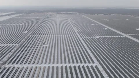 Sideways Aerial View Over Vast Photovoltaic Park in Winter, Germany Stock Footage 328723680