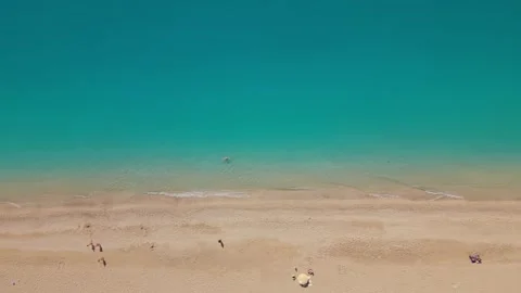 Sideways Drone Flight Above Sandy Beach and Crystal Clear Turquoise Sea Stock Footage 336514610