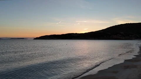 Sideways Drone Flight Along Sunrise Beach with Turquoise Waters Vídeo Stock 334705630