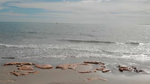 Sideways drone flight on a Mediterranean beach in sunshine. Stock Footage 135351054