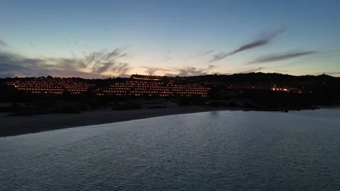 Sideways Drone Flight Over Sardinian Coastal Hotel and Sea at Sunset Vídeo Stock 334591970