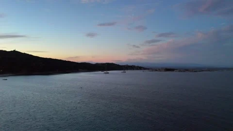 Sideways Drone Flight Over Sardinian Coastal Hotel and Sea at Sunset Vídeo Stock 334592164