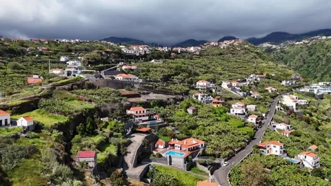 Sideways drone shot over the hillside town of Calheta, Madeira Stock Footage 310269793