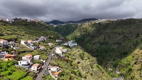 Sideways drone shot over the hillside town of Calheta, Madeira Stock Footage 310269826