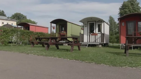 Sideways drone shot of small cabins in campground Video stock 333954417
