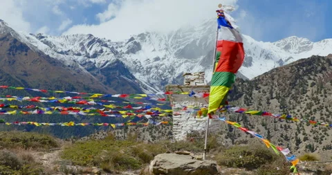 Sideways drone shot of a traditional Buddhist chorten with prayer flags in the Stock Footage 336339874