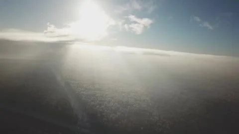 Sideways flight of the drone above the snowy forest and highway Stockbeeldmateriaal 333603882