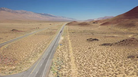 Sideways flight over a desert highway Stock Footage 142780541
