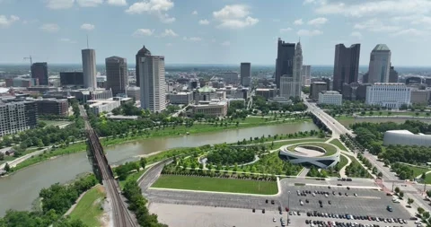 Sideways flight viewing downtown tall buildings and parks along the river Video stock 335671994