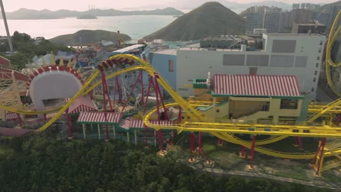 Sideways follow shot of fast moving 'Hair-Raiser' rollercoaster in Ocean Stock Footage 230223871