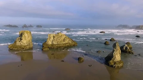 A sideways parallel shot of sun lit sea stack rock faces Stock-Footage 119657997