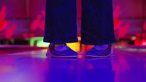 Sideways Sliding Dance Footwork With Toe and Heel Balance Beneath Neon Glow Mood Video stock 338420791