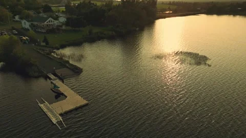 Sideways Spinning Drone Flight Over A Beautiful Lake With Dock And Boat Launch Stock-Footage 255310779