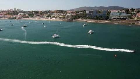Sideways tracking of fast moving speedboat in Cascais Bay, Portugal Stock Footage 245666709