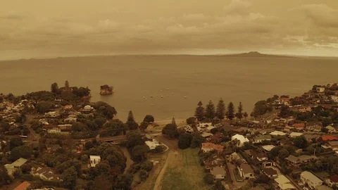 Sideways tracking shot over beach looking out to boats and volcano 4K HDR Stock Footage 122265821