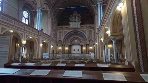 Sideways tracking view of prayer tables in Zion Neolog Synagogue, Oradea Stock Footage 325773214